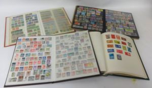 Collection of various stamp albums including commemoratives and loose stamps.
