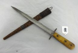 A dagger with horn handle and carved wood primitive scabbard, 40cm long