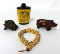 An erotic scent bottle, two netsukes and one bone bracelet decorated with skulls.