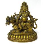 A Tibetan bronze Buddha sat on a lotus plinth, his jewellery and headdress with inset stones, height