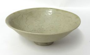 A Chinese celadon bowl, decorated with incised wavy design, probably Song dynasty, with small footed