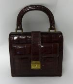 A vintage crocodile skin handbag