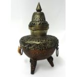 A mixed metal Asian centre piece with pierced decoration and cover, height 30cm.