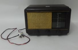 A Philco bakelite radio with spare glass window.