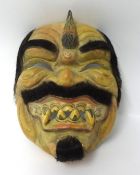 A carved wood Ramayana mask.