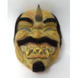 A carved wood Ramayana mask.