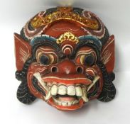 A carved wood Ramayana mask.