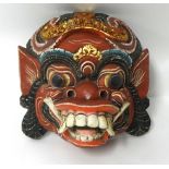 A carved wood Ramayana mask.