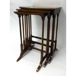 A mahogany nest of three tables, a reduced two door glazed cabinet and small Ercol elbow chair.