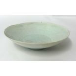 A small Chinese celadon glazed porcelain dish, with faint underglaze decoration, probably Song