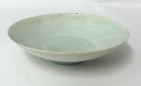 A small Chinese celadon glazed porcelain dish, with faint underglaze decoration, probably Song