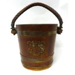 A Geo V brass bound wood fire bucket with rope handle and crest.