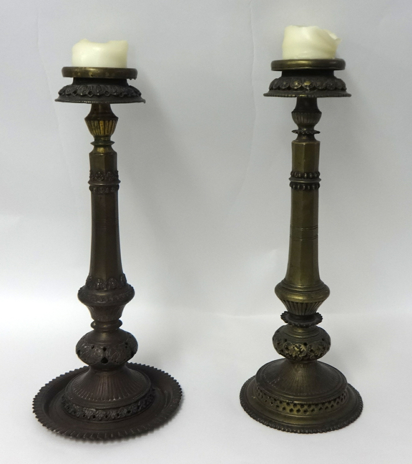 A pair of antique Nepalese brass candlesticks height, 53cm.