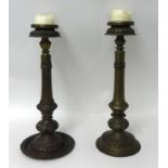 A pair of antique Nepalese brass candlesticks height, 53cm.