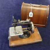 A 'Lead Miniatures' sewing machine in case.