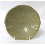 A small Chinese celadon glazed porcelain dish, with underglaze decoration, diameter 16cm.