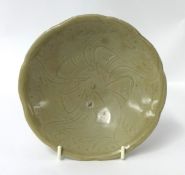 A small Chinese celadon glazed porcelain dish, with underglaze decoration, diameter 16cm.