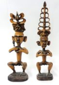 A pair of carved wood Eastern tribal figures, tallest 61cm.