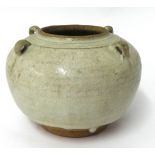 A Chinese pottery bowl decorated in off white drip glaze with on a plain stoneware foot rim, with