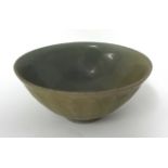 A Chinese celadon glazed bowl, with exterior underglaze petal decoration, probably Song dynasty,