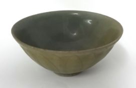 A Chinese celadon glazed bowl, with exterior underglaze petal decoration, probably Song dynasty,