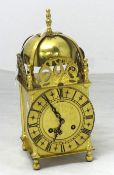 A reproduction brass lantern clock with German bell strike movement and key, 26cm high