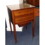 A mahogany three drawer sewing table on small castors