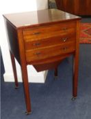 A mahogany three drawer sewing table on small castors