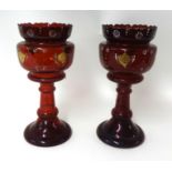 Pair of Victorian ruby glass lustres with enamelled decoration (no drops), height 36cm.