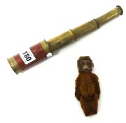 A pocket telescope and novelty monkey toy.