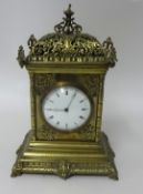 A late Victorian brass ornate 8 day clock, 30cm.