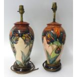 A pair of modern Moorcroft table lamps of baluster shape, height 42cm max.