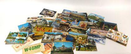 A large general collection of postcards within an oak four drawer cabinet.