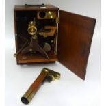 A brass table microscope in mahogany fitted case t/w various slides.