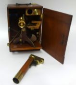A brass table microscope in mahogany fitted case t/w various slides.