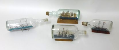Four model ships in bottles.