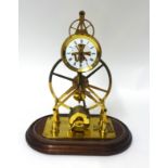 A reproduction brass skeleton clock with glass dome, height 37cm including dome.