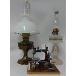 Victorian opaline glass oil lamp, brass oil lamp and a miniature sewing machine with case (3).