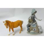 A Beswick Palomino horse and a Lladro figure.