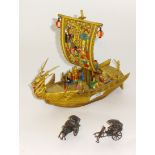 Pair of Chinese white metal miniature models of junks t/w a carved dragon boat set with figures.