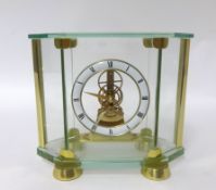 Early brass cased and glass panel battery operated clock with mechanical movement by Woodford (Est