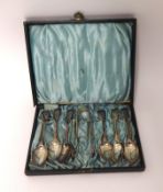 An Edwardian silver set of six fiddle pattern tea spoons, London 1901, and a pair of sugar tongs,