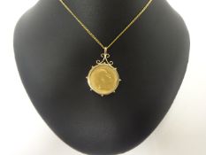 A 1910 sovereign mounted pendant, set in a loose mount, chain, gross weight 13.9 grams.