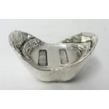 A Chinese Qing silver sycee or ingot, of boat shape, bearing character marks, weight 11.7 oz, length