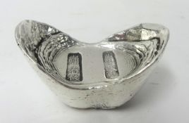 A Chinese Qing silver sycee or ingot, of boat shape, bearing character marks, weight 11.7 oz, length