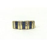 A 14kt gold, sapphire and diamond panel ring, set with three rows of baguette cut sapphires with