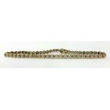 A 9ct gold and diamond line bracelet, set with single cut stones, weight 5.8 grams.