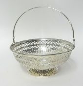 A silver swing handle basket, Sheffield 1912, of circular form with a pierced body, diameter 16