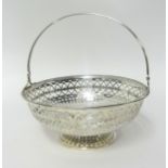 A silver swing handle basket, Sheffield 1912, of circular form with a pierced body, diameter 16