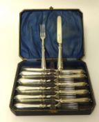 A Victorian silver set of dessert knives and forks, Birmingham 1846, crested and monogrammed, cased.